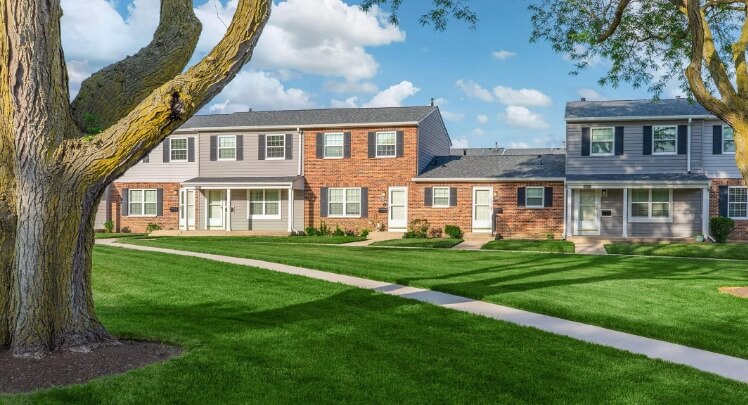 Brick apartment building with green lawn
