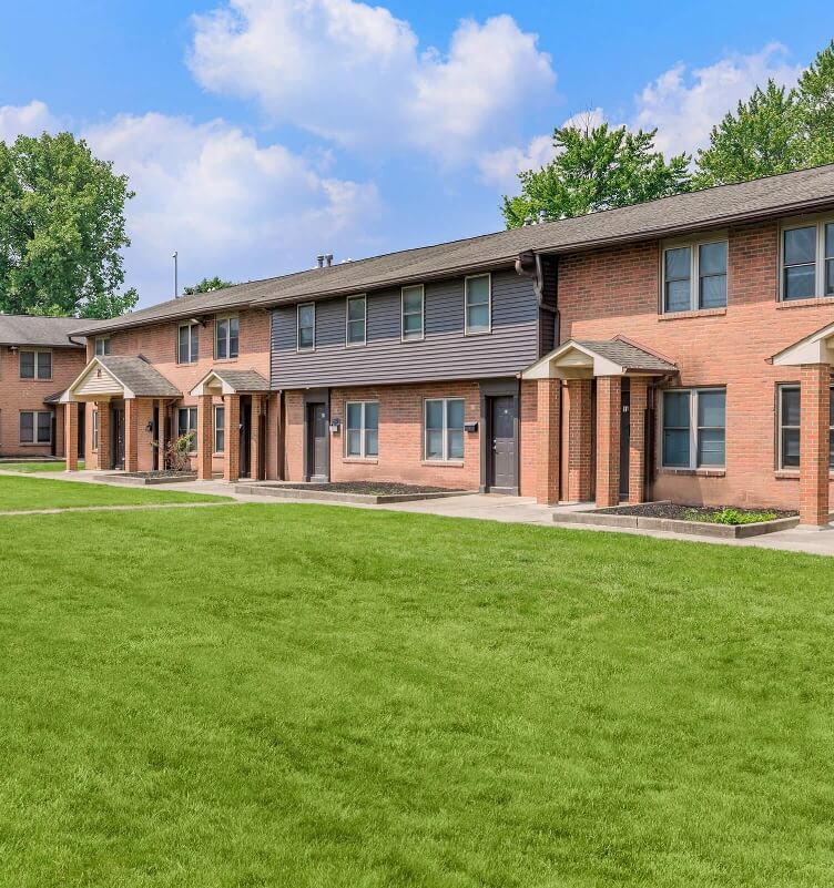 Apartment building with large tree in front